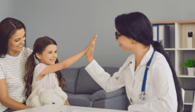 Smiling international patient and doctor in a modern hospital, representing medical tourism services for affordable and quality treatments in India.